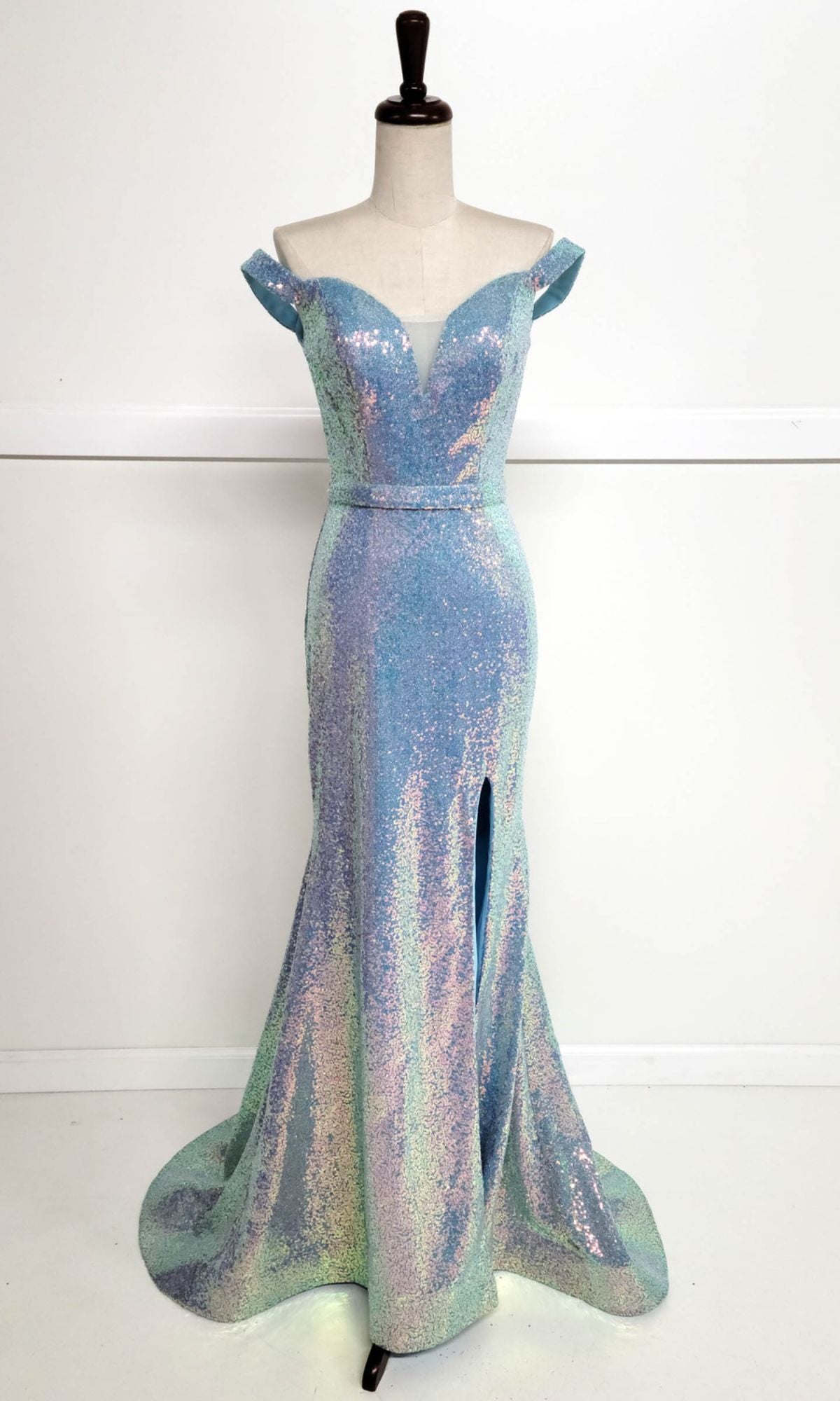 The Off-Shoulder Long Sequin Prom Dress: Chicas C324 features a fitted bodice, deep V neckline, and front slit, shown on a dress form against a plain white background.